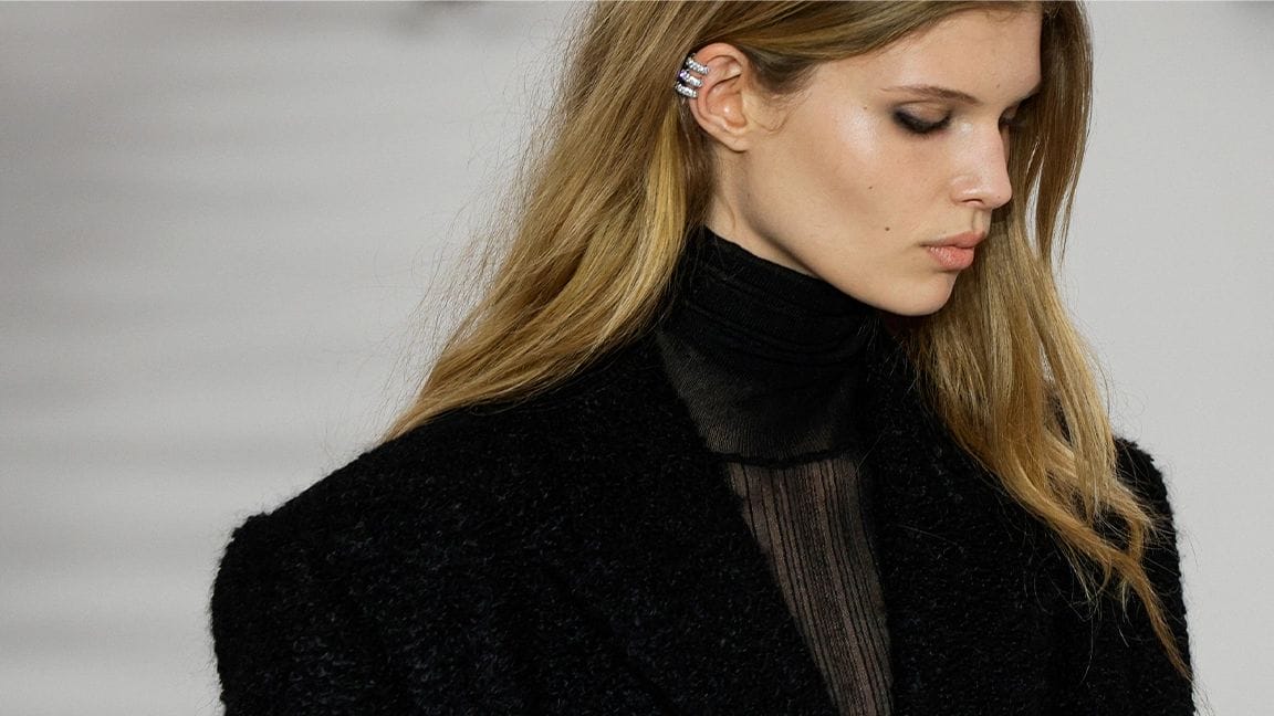 givenchy fall/winter 2023
women wearing a black shirt looking down