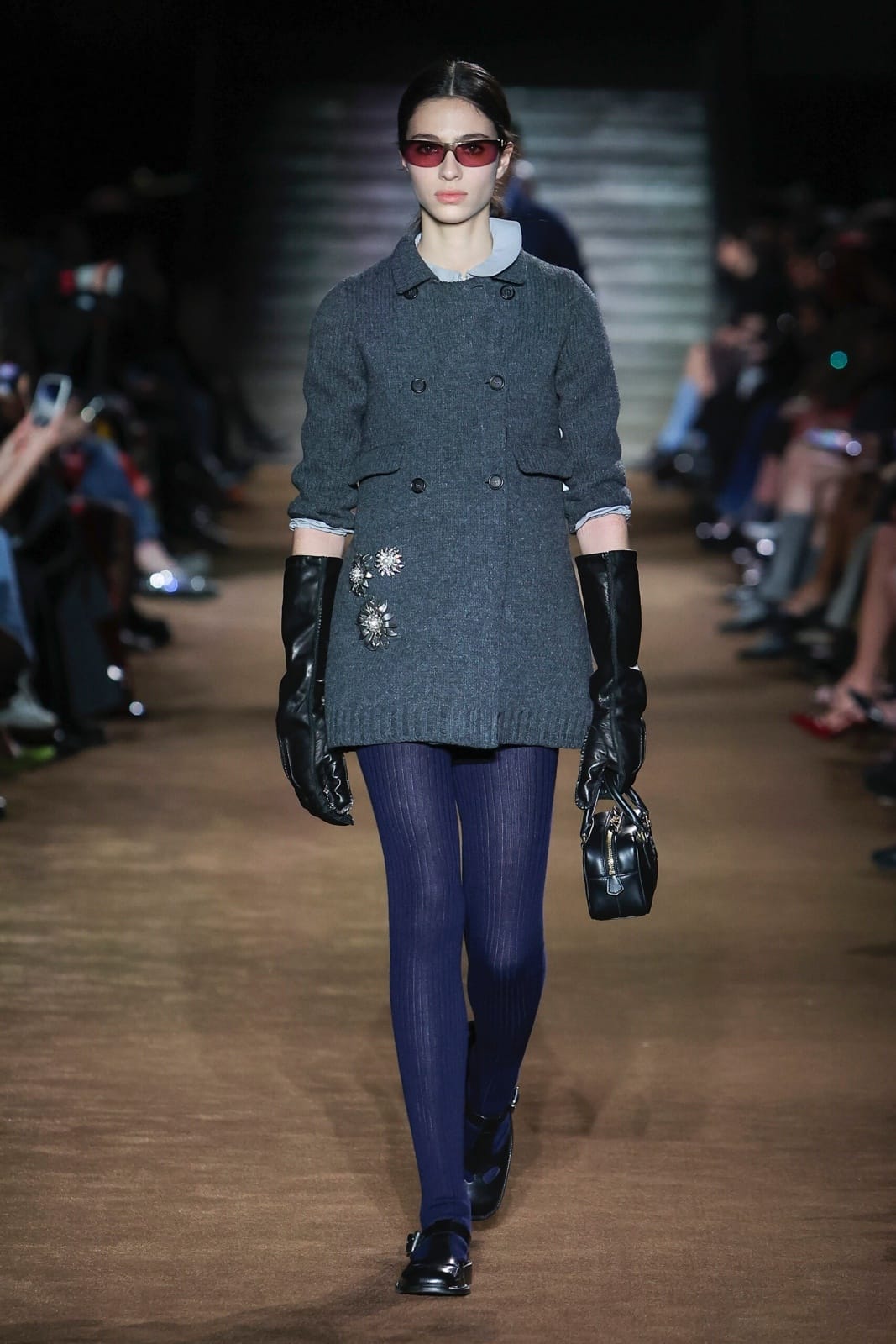 Miu Miu’s Fall/Winter 2024 show kicked off with a slew of refined double-breasted coats, pearl necklaces and oversized gloves