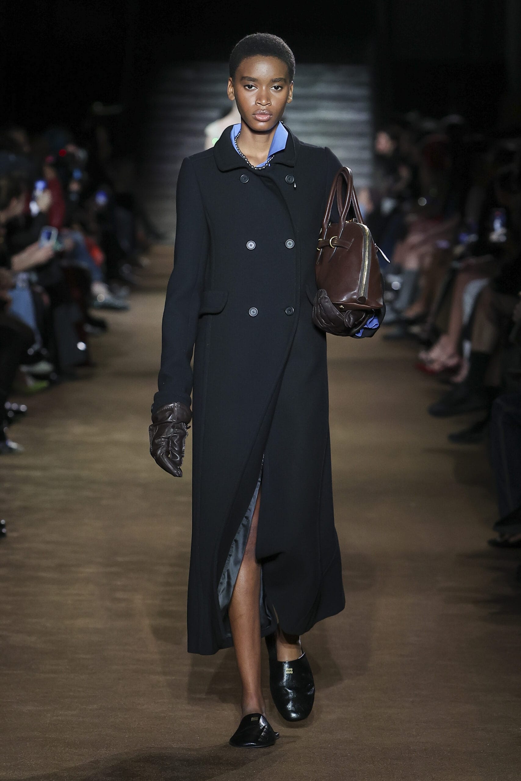 Miu Miu’s Fall/Winter 2024 show kicked off with a slew of refined double-breasted coats, pearl necklaces and oversized gloves